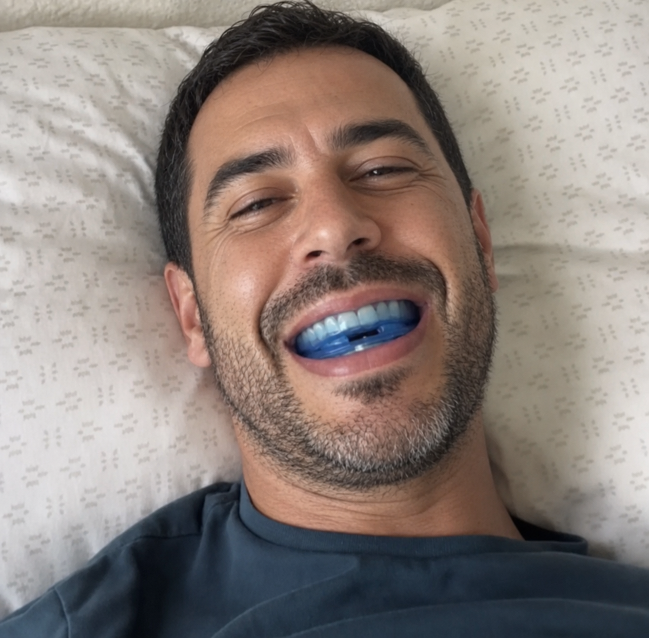 Man laughing while wearing the mouthpiece