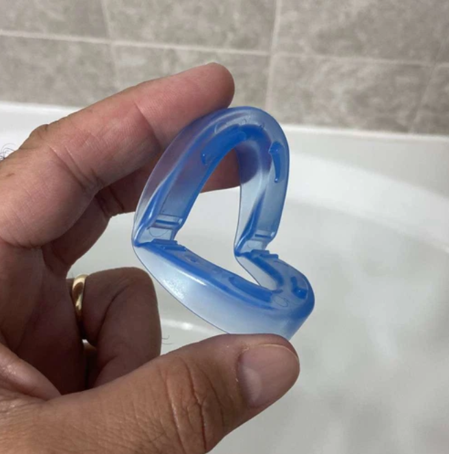 Mouthpiece being rinsed in a bathroom